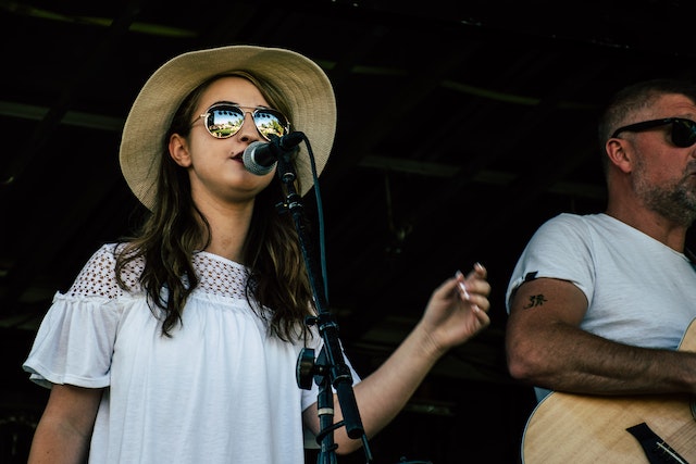 Singing girl with sunglasses.